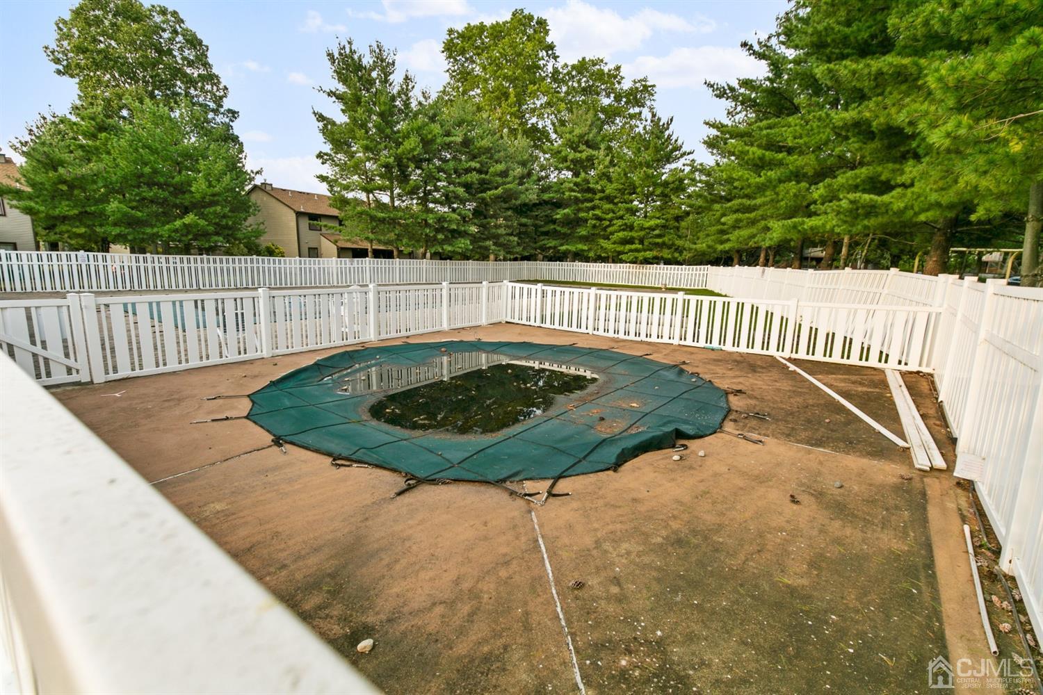 7303 Hana Road Edison, NJ 08817 - Photo 23 of 24 a view of a swimming pool with a yard