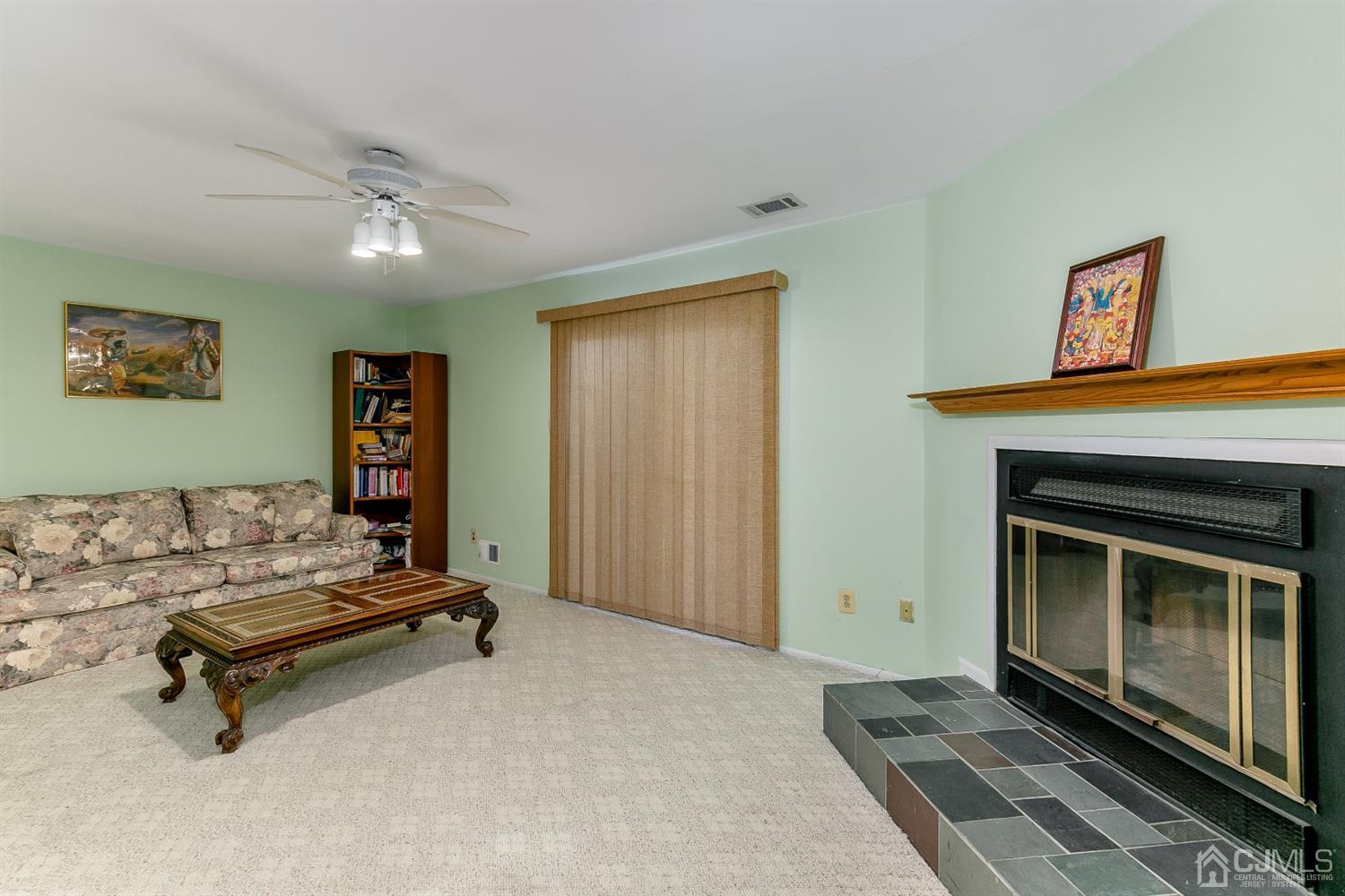 7303 Hana Road Edison, NJ 08817 - Photo 6 of 24 a living room with furniture and a fireplace