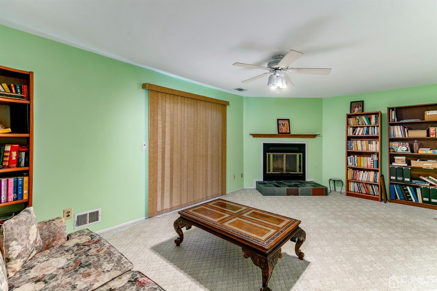 7303 Hana Road Edison, NJ 08817 - Photo 7 of 24 a living room with furniture and a fireplace