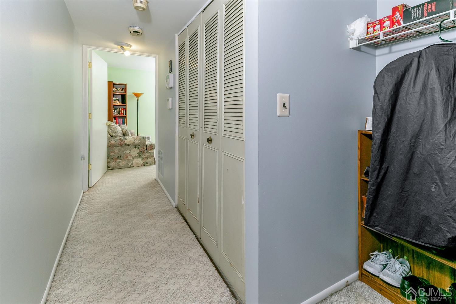 7303 Hana Road Edison, NJ 08817 - Photo 8 of 24 a view of a hallway to a livingroom with furniture