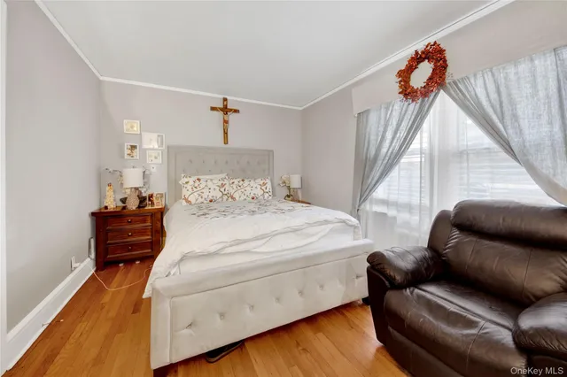 a bedroom with furniture and wooden floor