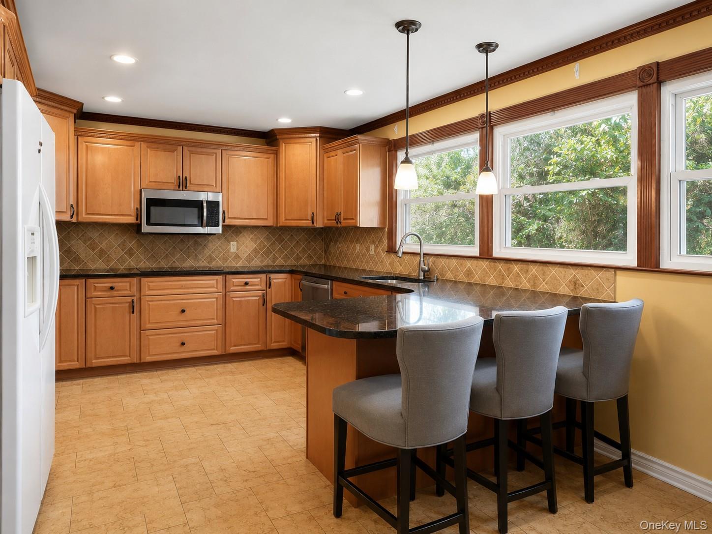 180 Sutton Manor Road New Rochelle, NY 10801 - Photo 2 of 9 a kitchen with stainless steel appliances granite countertop a stove a sink and a refrigerator