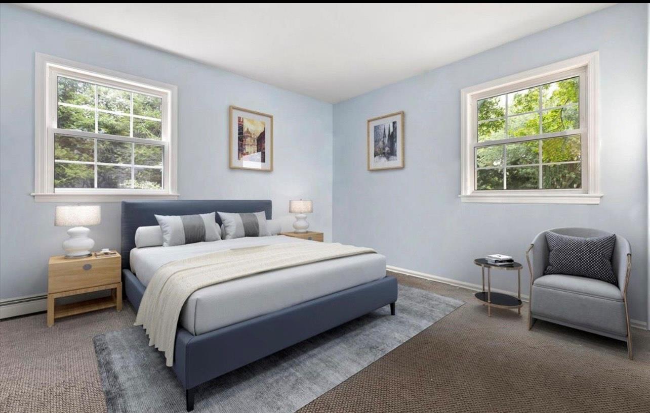 240 Plainview Road Woodbury, NY 11797 - Photo 11 of 22 a bedroom with a bed and a couch with window