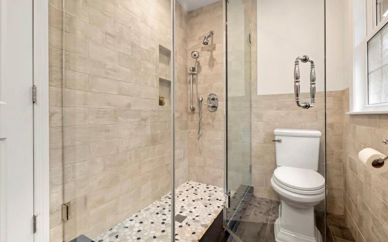 240 Plainview Road Woodbury, NY 11797 - Photo 12 of 22 a bathroom with a toilet and a shower