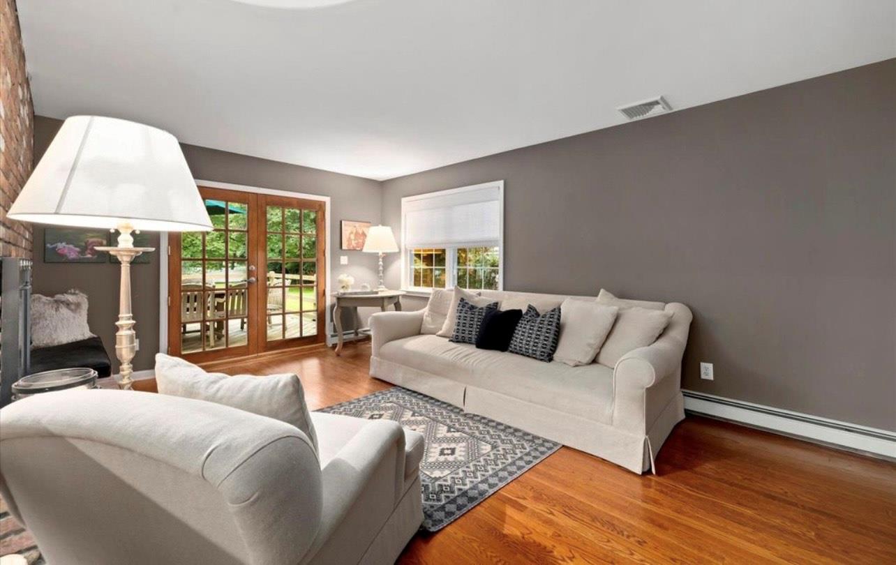 240 Plainview Road Woodbury, NY 11797 - Photo 3 of 22 a living room with furniture and a lamp