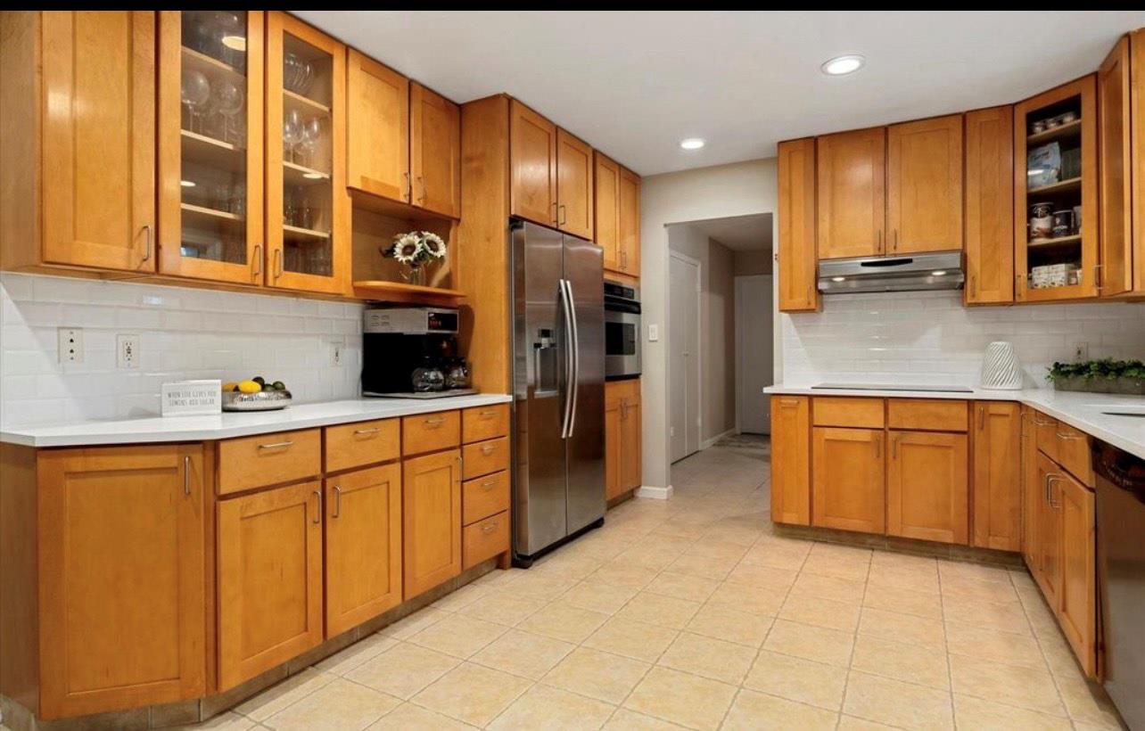 240 Plainview Road Woodbury, NY 11797 - Photo 5 of 22 a kitchen with stainless steel appliances granite countertop a refrigerator and a sink