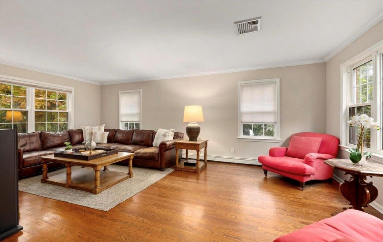 240 Plainview Road Woodbury, NY 11797 - Photo 7 of 22 a living room with furniture and a window