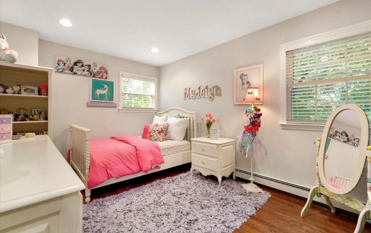 240 Plainview Road Woodbury, NY 11797 - Photo 10 of 22 a bed room with a bed and a chair