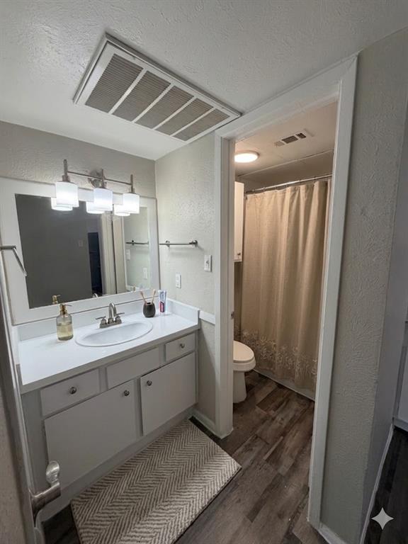 11457 Dennis Road, Unit 301 Dallas, TX 75229 - Photo 6 of 6 a bathroom with a double vanity sink and mirror