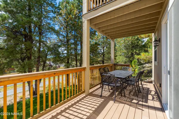 a view of balcony with furniture and wooden floor