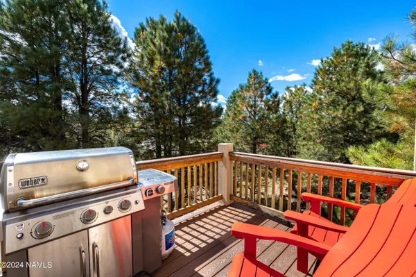 a view of a roof deck with wooden floor and fence