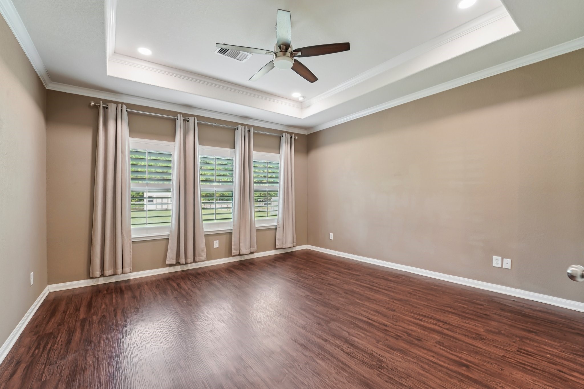 4542 Coues Deer Lane Conroe, TX 77303 - Photo 27 of 50 Bright primary bedroom featuring three windows for abundant natural light.