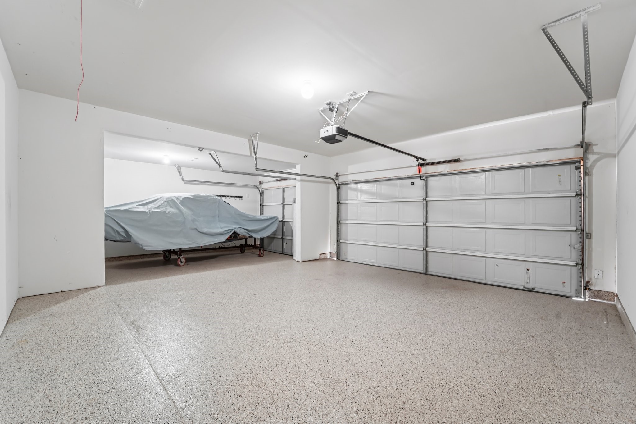 4542 Coues Deer Lane Conroe, TX 77303 - Photo 39 of 50 Spacious, well-lit garage with ample storage and parking featuring sleek, durable flooring.