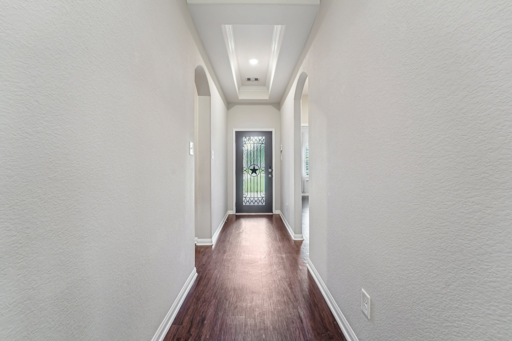 4542 Coues Deer Lane Conroe, TX 77303 - Photo 4 of 50 Welcome home to a stunning entrance featuring elegant wood floors and a beautifully crafted door, setting the tone for the sophistication within.