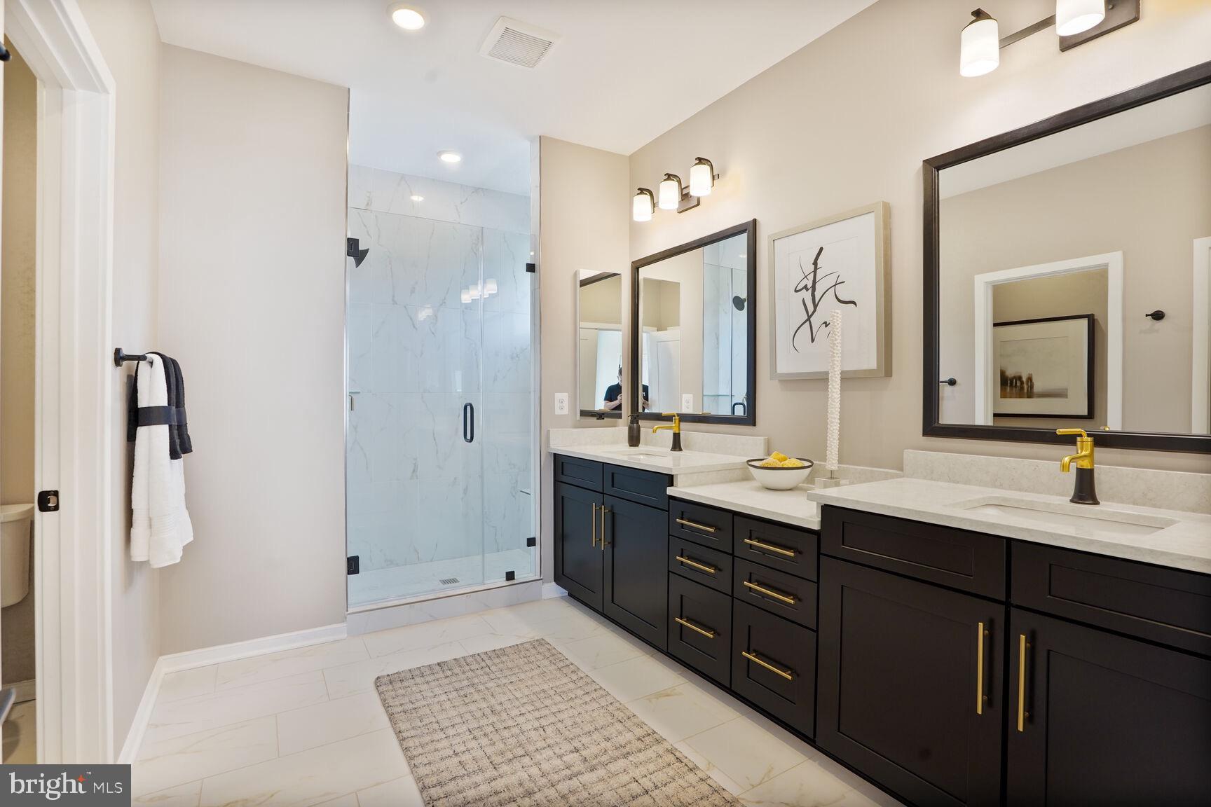 42116 Hazel Grv Terrace Ashburn, VA 20148 - Photo 11 of 21 a bathroom with a double vanity sink and mirror
