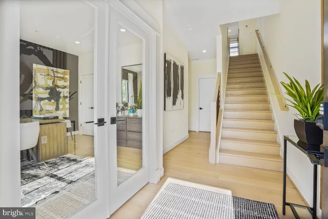a view of a hallway view with wooden floor and windows