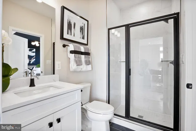 a bathroom with a toilet sink and a mirror