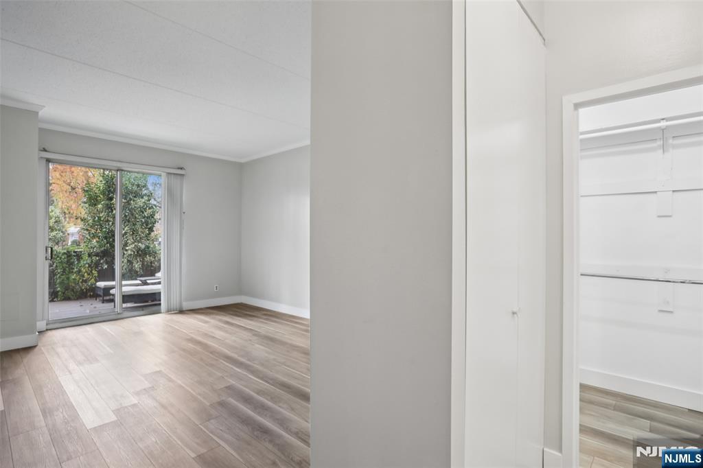 1077 River Road, Unit TH5 Edgewater, NJ 07020 - Photo 11 of 22 a view of an empty room with wooden floor and a window