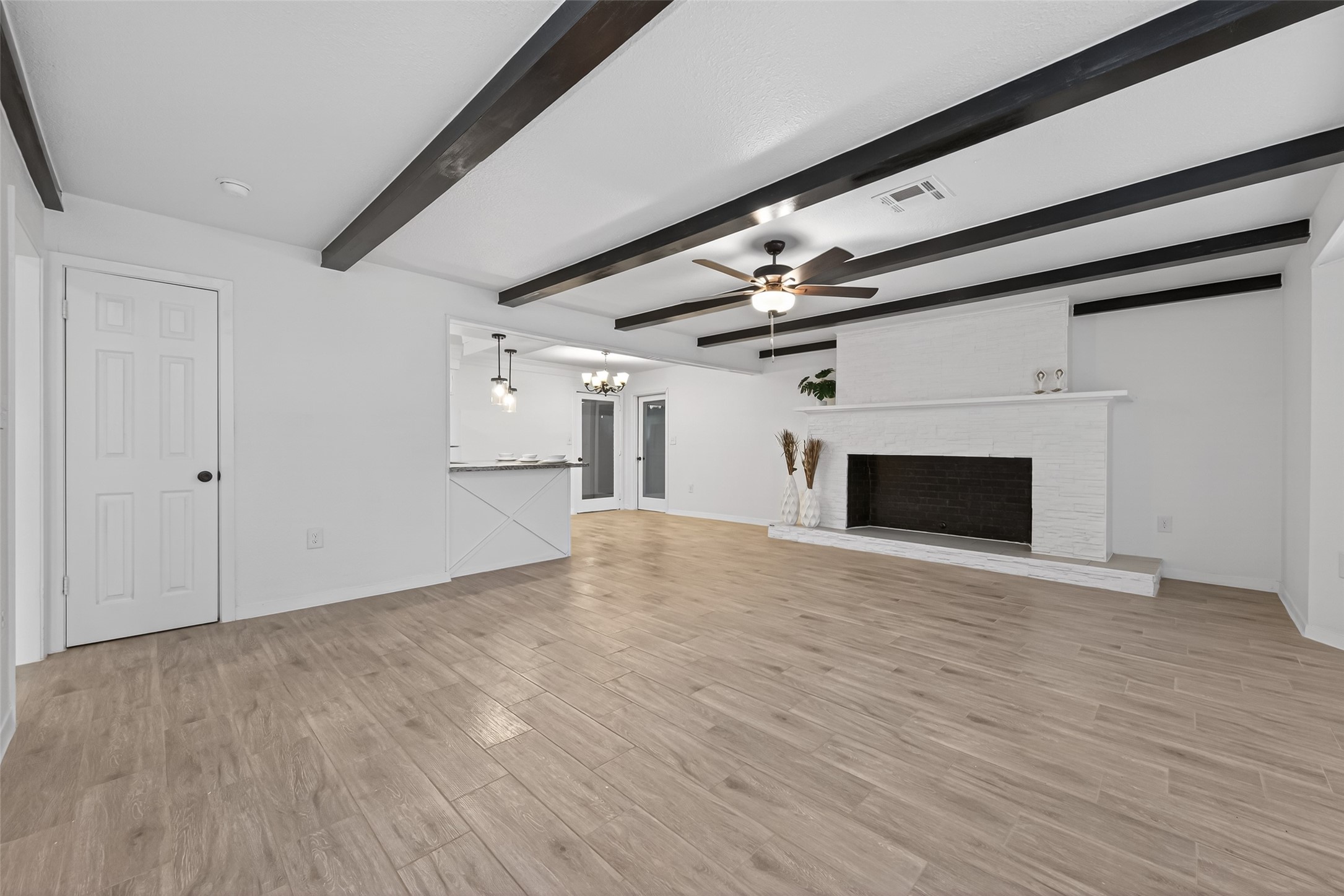 7718 Morley Street Houston, TX 77061 - Photo 4 of 35 a view of empty room with wooden floor and fireplace