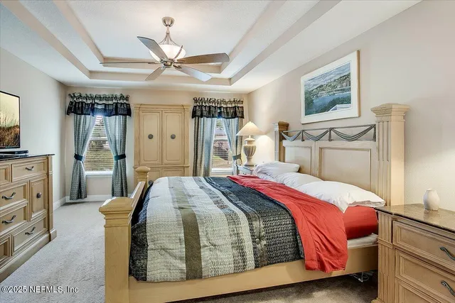 a bedroom with a large bed closet and flat tv screen