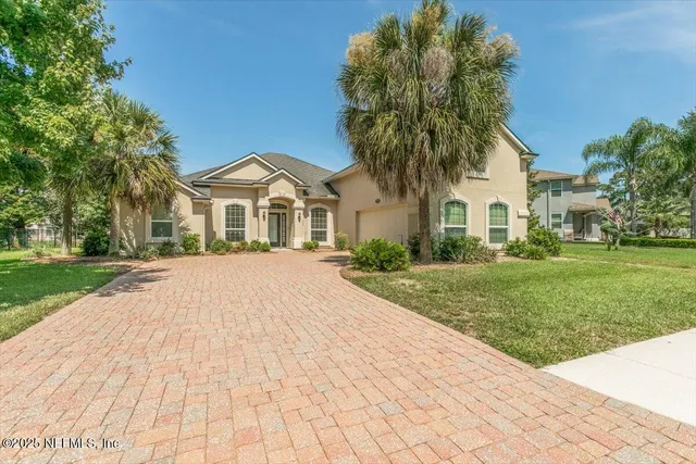 a front view of a house with a garden