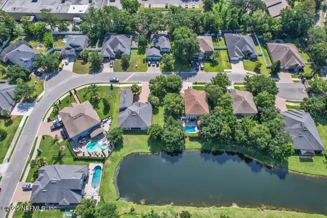 an aerial view of a house with swimming pool and outdoor space