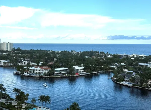 an view of a lake with boats and trees in the background
