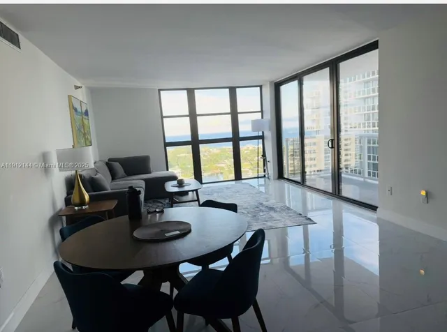 a dining room with furniture and window