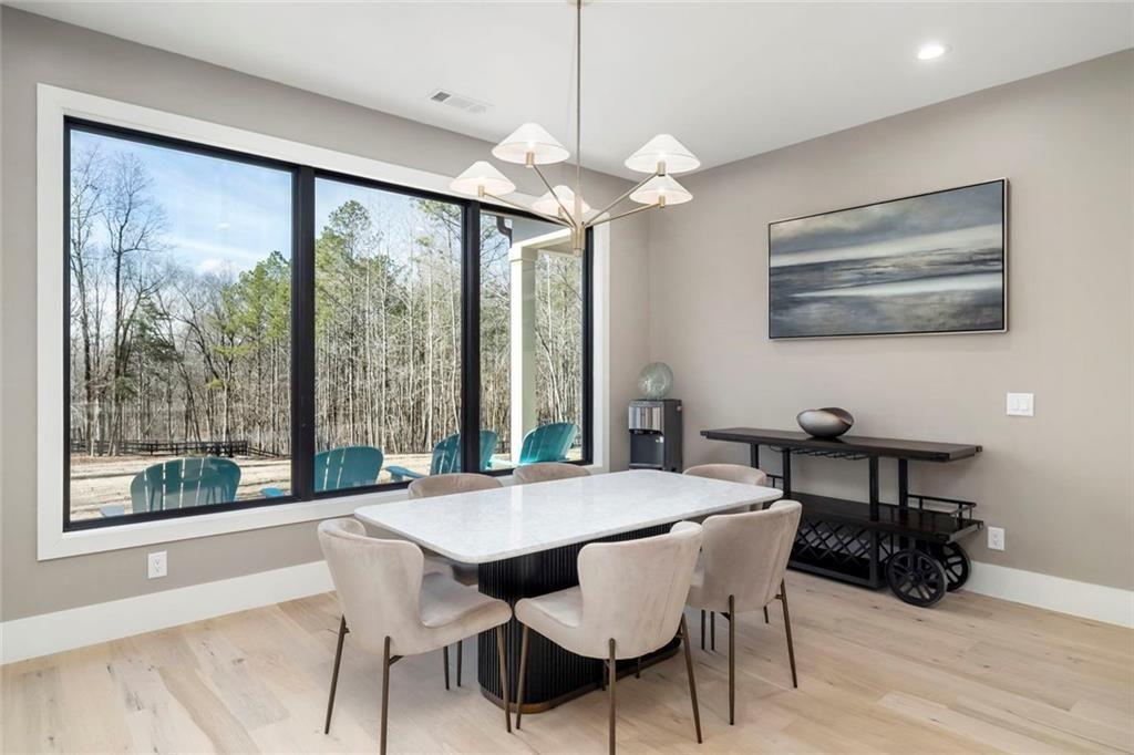 2309 Dinsmore Road Milton, GA 30004 - Photo 19 of 87 a view of a dining room with furniture window and wooden floor