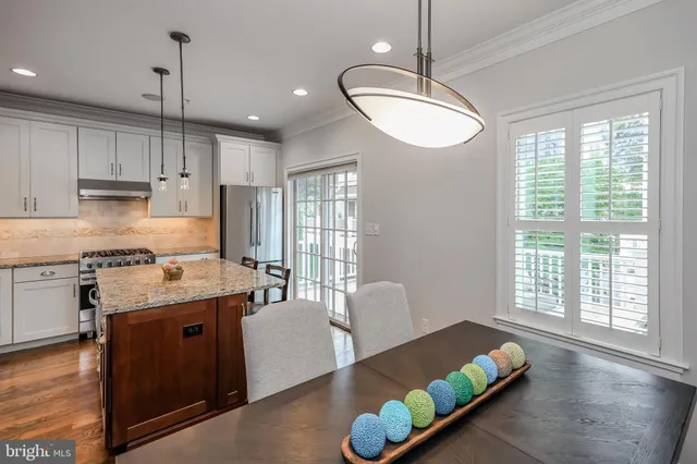 an empty room with windows and furniture