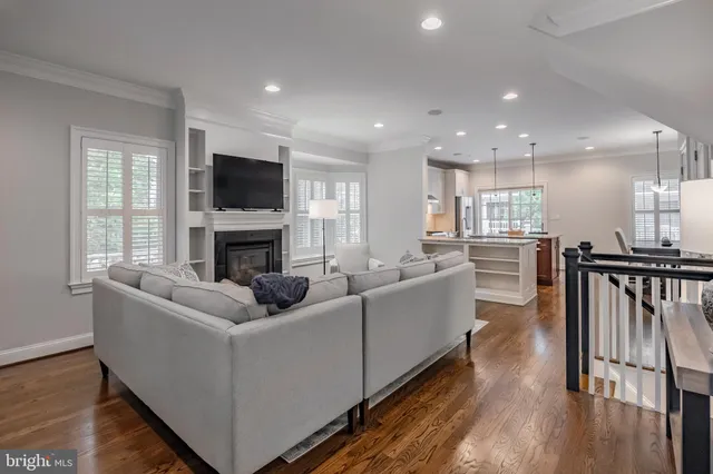 a living room with furniture and a view of kitchen