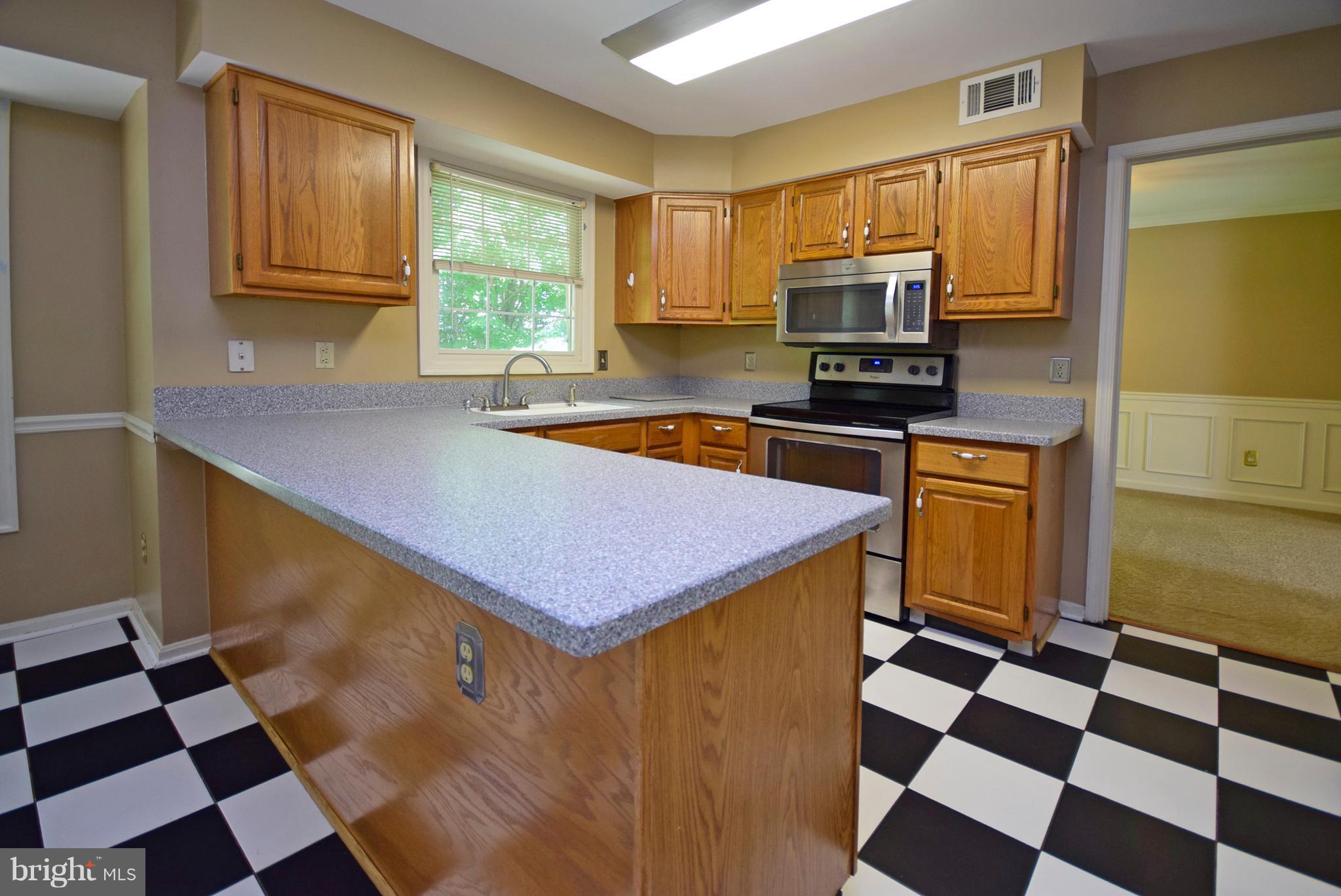 9 Charleston Court Stafford, VA 22554 - Photo 7 of 30 a kitchen with a sink a stove and a refrigerator
