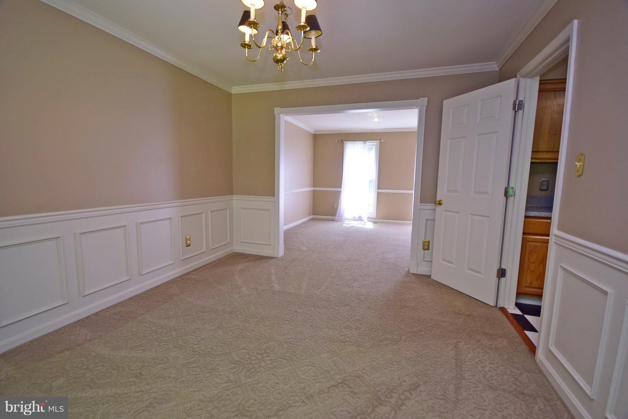 9 Charleston Court Stafford, VA 22554 - Photo 10 of 30 a view of a big room with windows and chandelier