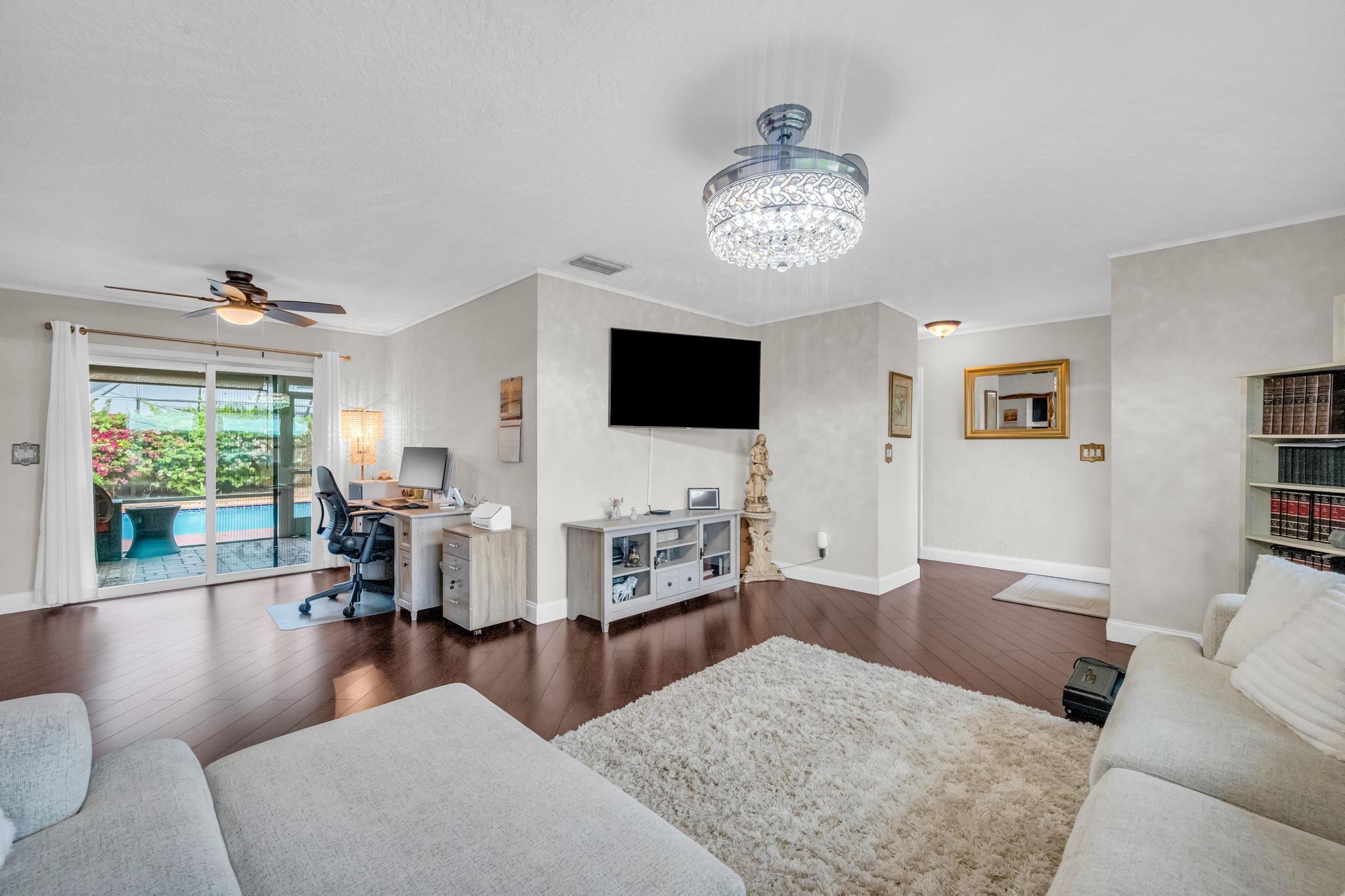 4167 Russell Street Jupiter, FL 33469 - Photo 15 of 60 a living room with furniture and a flat screen tv