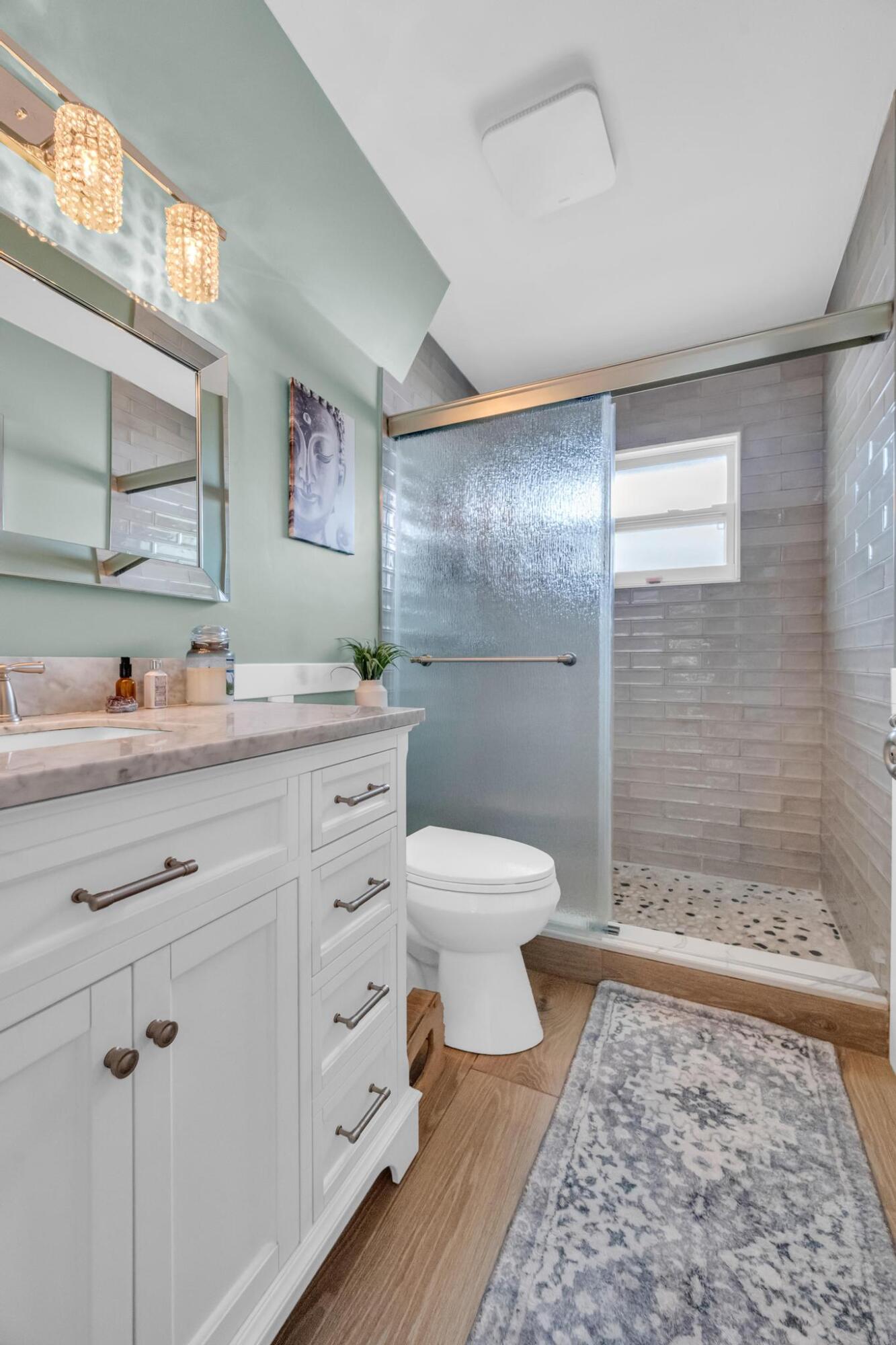 4167 Russell Street Jupiter, FL 33469 - Photo 23 of 60 a bathroom with a granite countertop sink toilet and shower