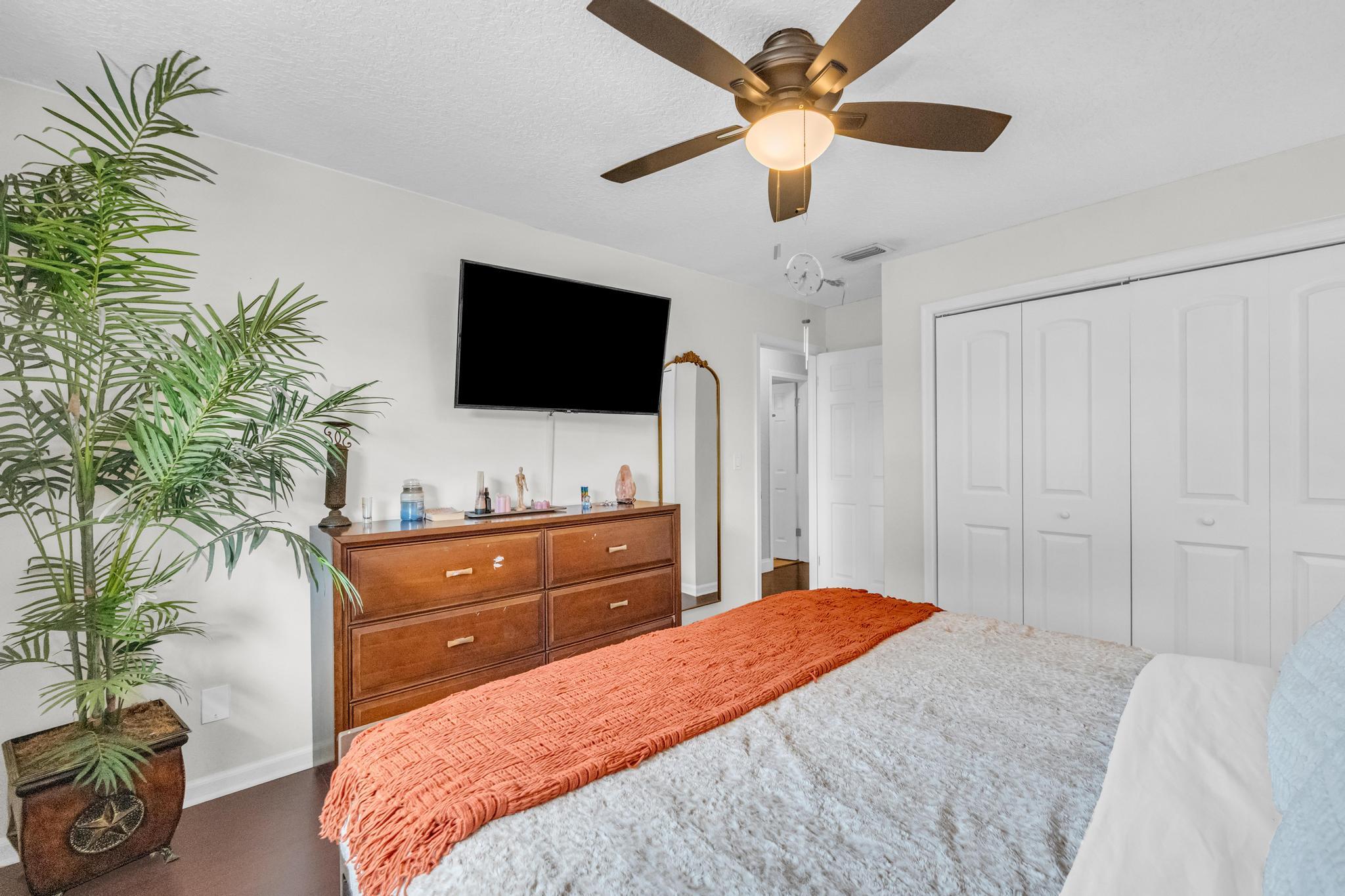 4167 Russell Street Jupiter, FL 33469 - Photo 26 of 60 a bedroom with a large bed and a flat screen tv