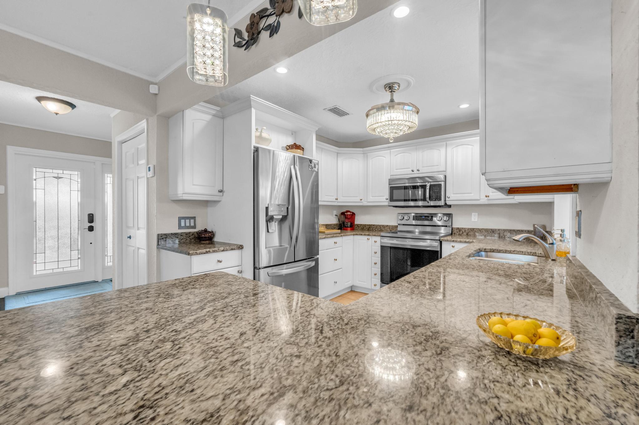 4167 Russell Street Jupiter, FL 33469 - Photo 3 of 60 a kitchen with refrigerator a sink and a stove