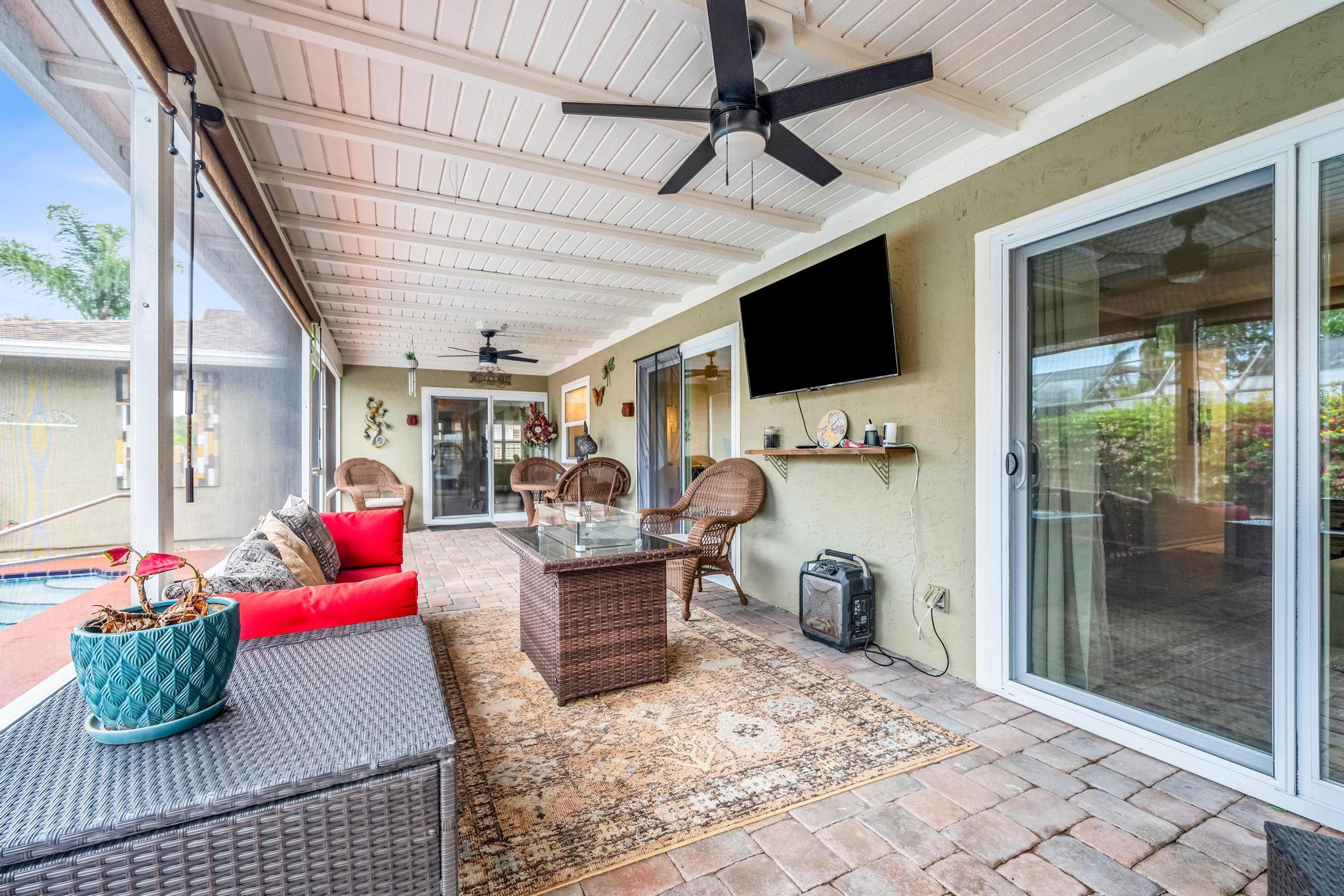 4167 Russell Street Jupiter, FL 33469 - Photo 37 of 60 a living room with furniture and a flat screen tv