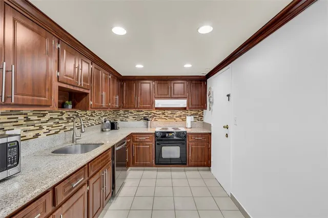 a kitchen with wooden cabinets and stainless steel appliances