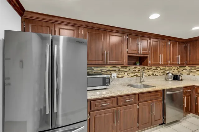 a kitchen with stainless steel appliances granite countertop a sink stove oven and refrigerator