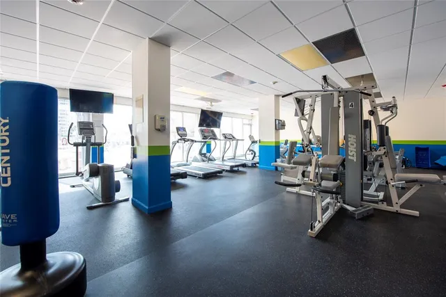 a large kitchen with stainless steel appliances kitchen island granite countertop a sink and cabinets