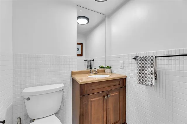 a bathroom with a toilet a sink and mirror