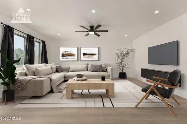 an empty room with fan and windows