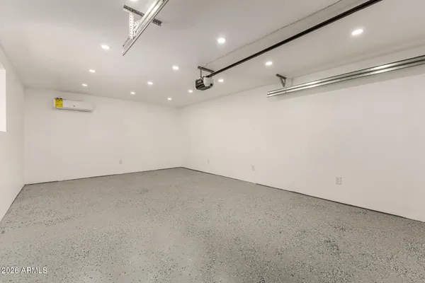 an empty room with a cabinet and mirrors