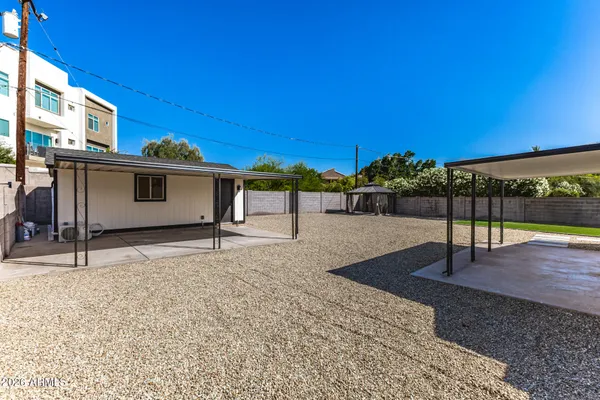 an aerial view of a house with swimming pool and patio