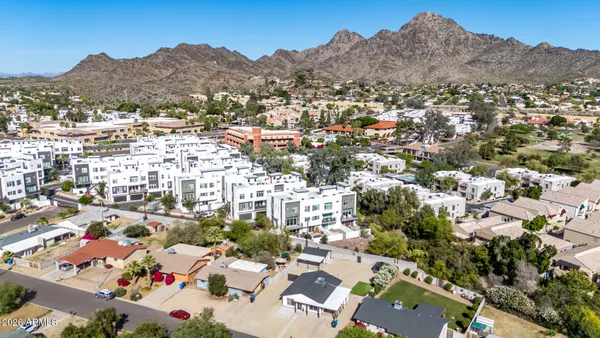 an aerial view of a house with a garden and swimming pool
