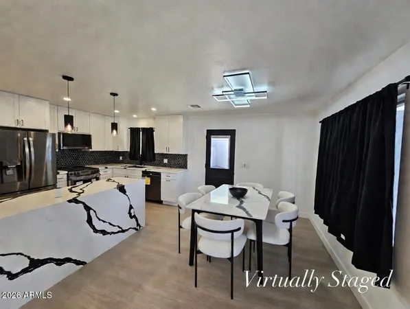 a view of a kitchen with refrigerator and windows