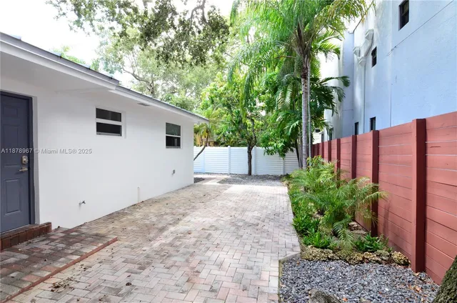 a backyard of a house with plants and trees