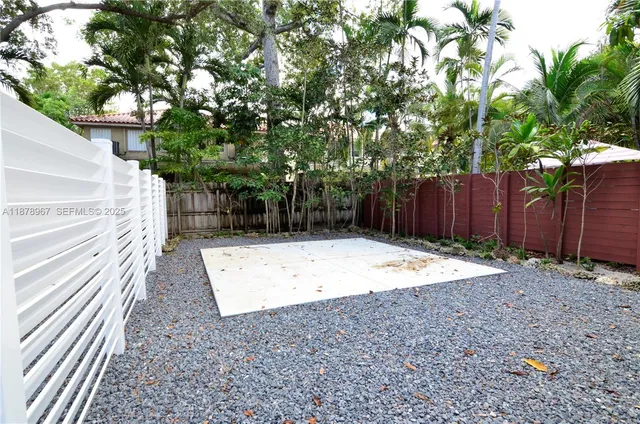 a view of a backyard with a tree