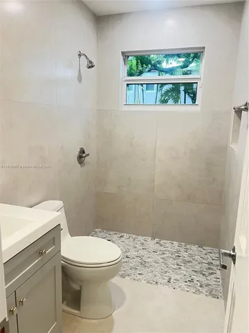 a bathroom with a toilet a sink and a shower